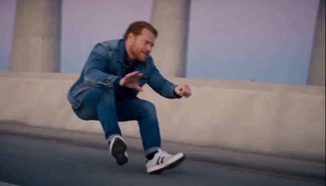 Opening frame of the generated chase, with the denim-clad rider crouching above the road